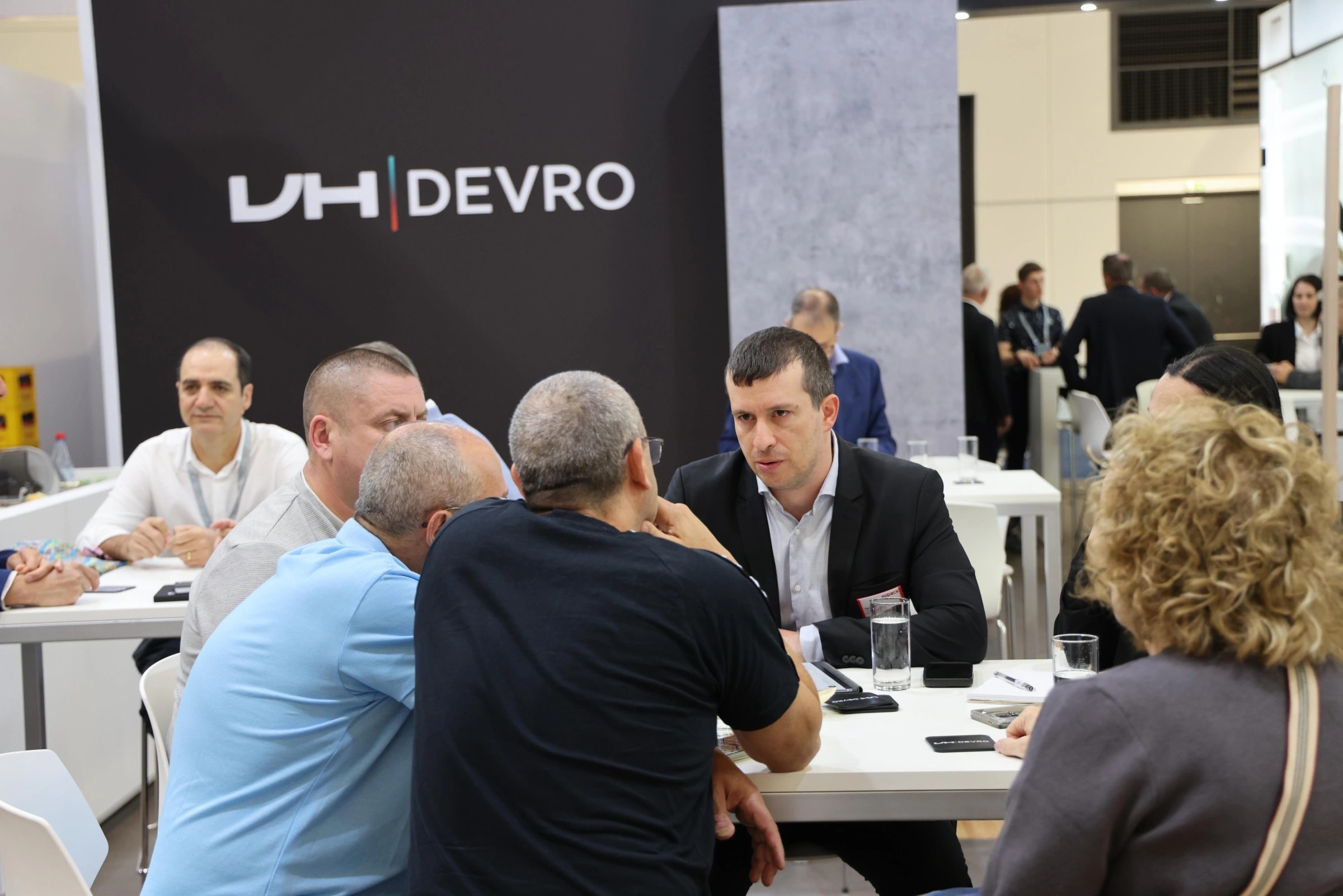 Kopack representatives meeting suppliers at the DEVRO stand during a trade fair