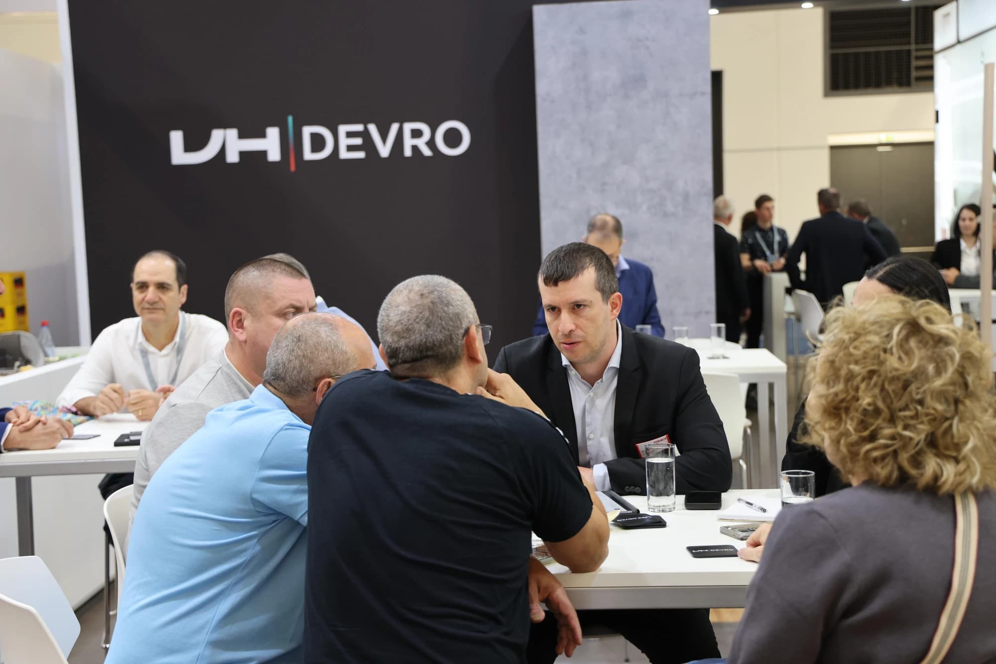 Kopack representatives meeting suppliers at the DEVRO stand during a trade fair