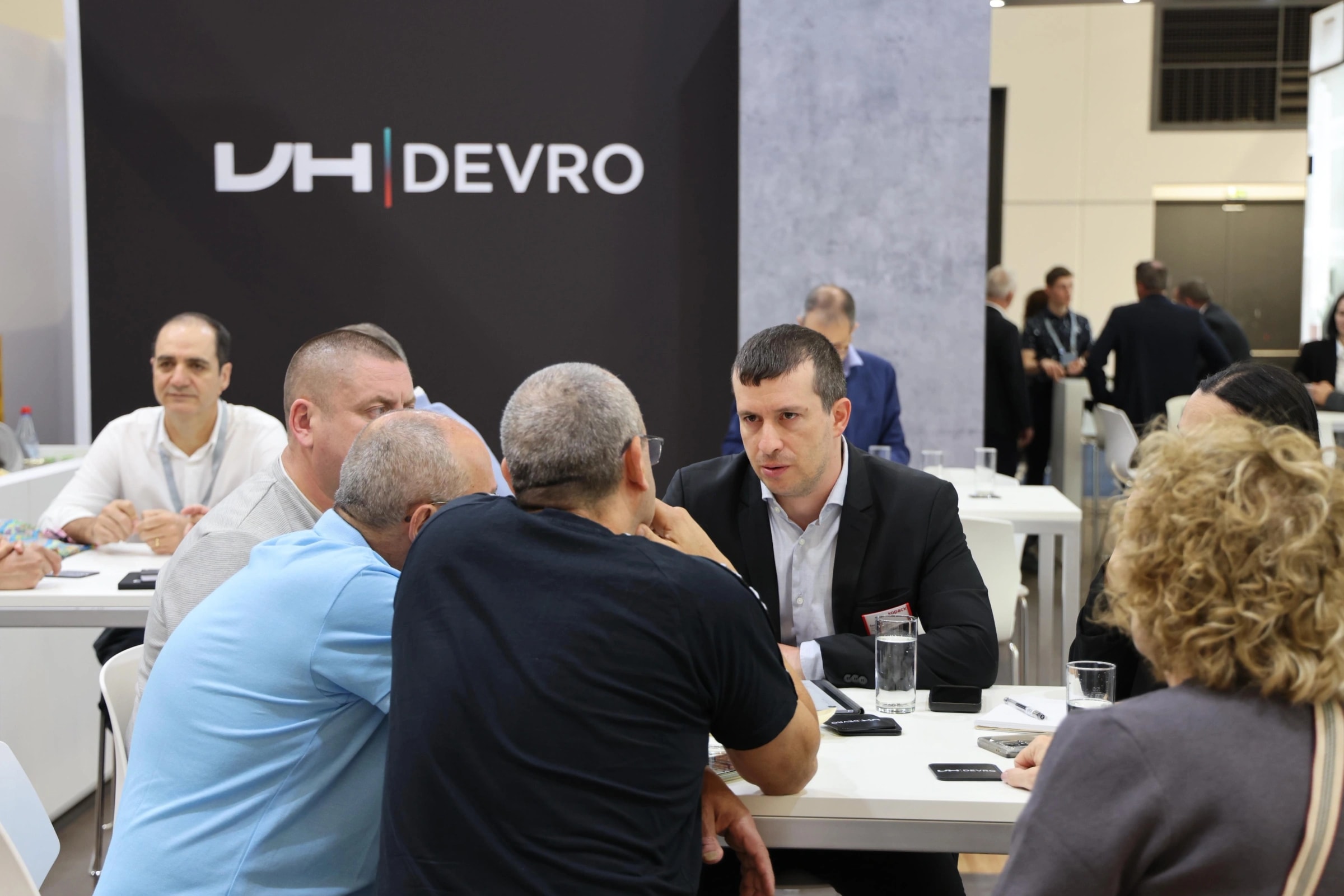 Kopack representatives meeting suppliers at the DEVRO stand during a trade fair